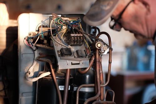 Chicago HVAC Pros technician working on refrigeration components
